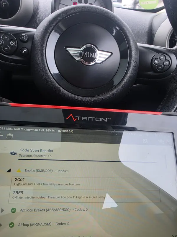 Diagnostic scanner in a Mini at Village Motor Center, Warrington, showing fault codes for low high-pressure fuel and injection cut-out